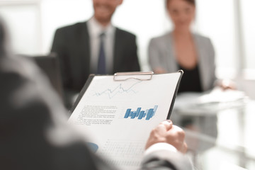 background image of a businessman checking financial documents.