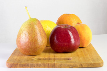 Fototapeta na wymiar red apple, pear, lemon, orange, peach on white background, copy space