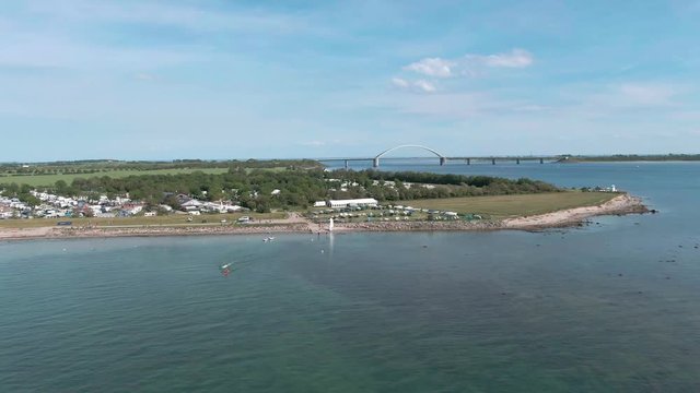 droneshot of a campsite at the beach, with lighthouse on a sunny day