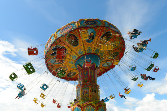 June 10, 2018: Children ride on the carousel in an amusement park against a blue sky. Cheboksary. Russia.