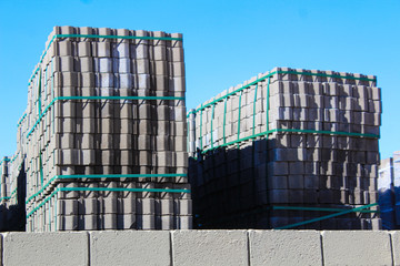 Piles of concrete construction elements stored at a factory yard