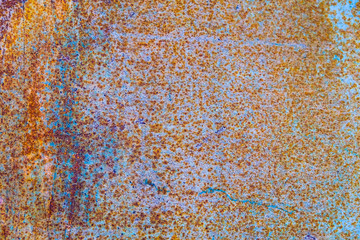Old corroded metal wall background with flaky blue green paint .Rusty flaky cracked metal surface.Abstract the surface texture of the old metal.