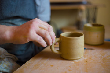 Professional male potter working in workshop, studio