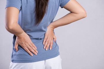 Close up woman having pain in injured back. Healthcare and back pain concept.
