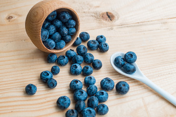 Many fresh bluederry on the wooden table close up