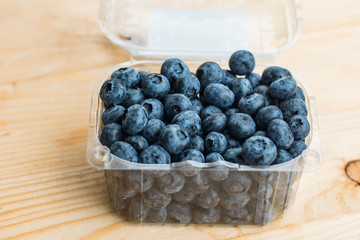 Many fresh bluederry on the wooden table close up