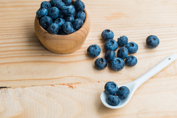 Many fresh bluederry on the wooden table close up