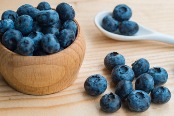 Many fresh bluederry on the wooden table close up