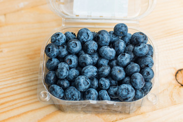 Many fresh bluederry on the wooden table close up