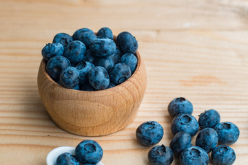 Many fresh bluederry on the wooden table close up