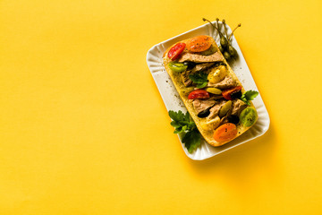 sandwich with canned tuna, capers and tomatoes with parsley on a yellow background