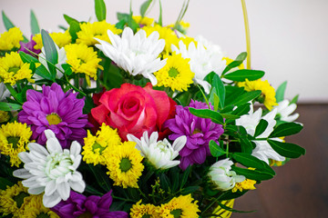 Bouquet of flowers: pink roses and multicolored chrysanthemums.