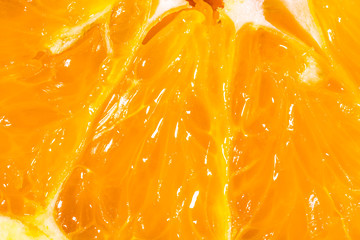 Closeup texture of an orange fruit slice. Fruit natural macro background