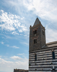 Fototapeta na wymiar Portovenere, Italy. Seaside village with the gulf of poets that inspired the poems of Byron, a popular tourist destination for beach holidays and tracking. San Pietro church.