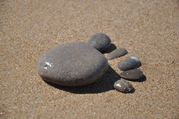 Fototapeta na wymiar Foot made of stone on the sand