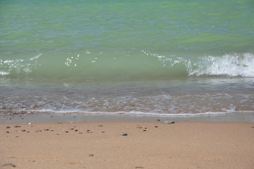 Azure sea, beach, blue sky with feather clouds