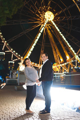 couple holding hands at night