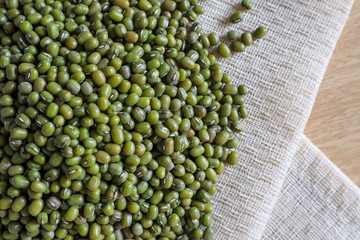 Mung bean seeds have long been used as food for human beings, green beans, seeds that are placed in a white plate, placed on a table with tears and tablecloths....