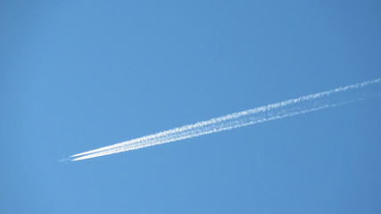 the trace of the plane in the summer sky