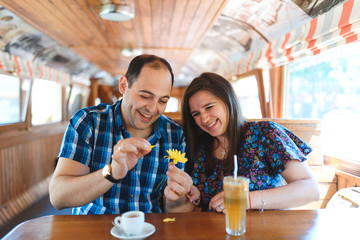 couple plucking petals from flower