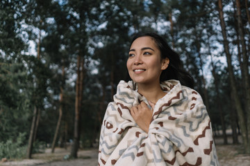 Beautiful asian woman with happy emotional face breathing fresh air in green park, thinking, enjoying landscapes. Authentic portrait of happy Korean girl relaxing outdoors 