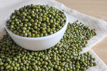 Mung bean seeds have long been used as food for human beings, green beans, seeds that are placed in a white plate, placed on a table with tears and tablecloths....