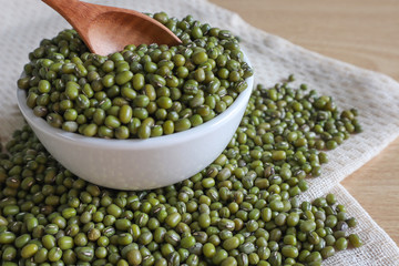 Mung bean seeds have long been used as food for human beings, green beans, seeds that are placed in a white plate, placed on a table with tears and tablecloths....