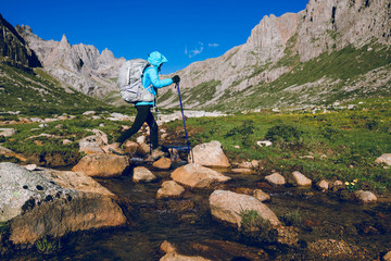 Woman hiker hiking on high altitude mountains