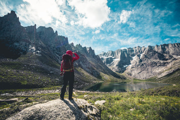 Fototapeta na wymiar Woman hiker hiking on high altitude mountains