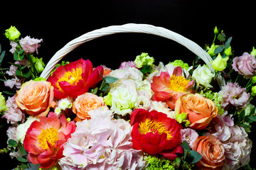 bright white flower arrangement in a basket on a dark background