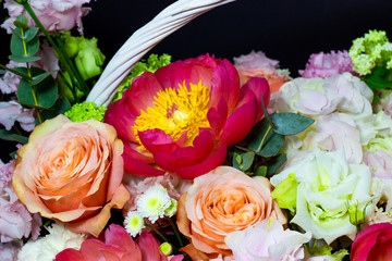bright white flower arrangement in a basket on a dark background