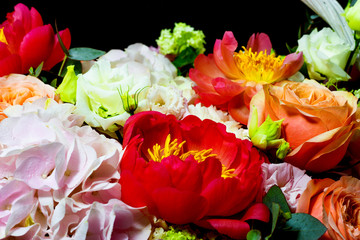 bright white flower arrangement in a basket on a dark background