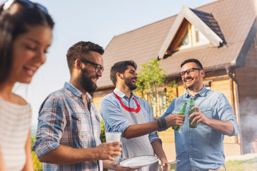 Friends making backyard barbecue party