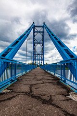 Scenic metal pedestrian bridge across the river