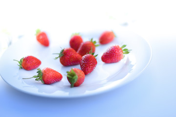 sweet and juicy strawberries isolated on white plate