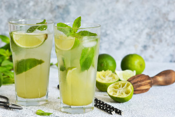 Mojito is a traditional summer cold drink with lime, mint and alcohol. Summer drink.