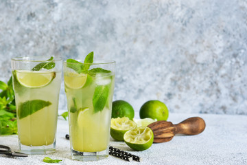 Mojito is a traditional summer cold drink with lime, mint and alcohol. Summer drink.