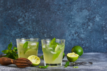 Summer cold drink - mahito with lime and mint on a concrete dark background.