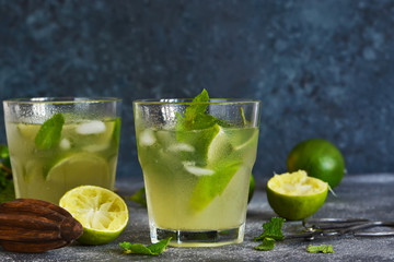 Summer cold drink - mahito with lime and mint on a concrete dark background.