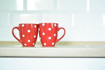 red cup with dots on kitchen table