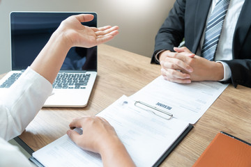 Business consulting candidate employee in suit looking skeptical reading a resume, hr speaking at job interview and recruitment concept.