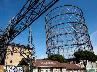 Walking along the Tiber with Gazometro view 5
