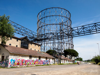 Walking along the Tiber with Gazometro view 6