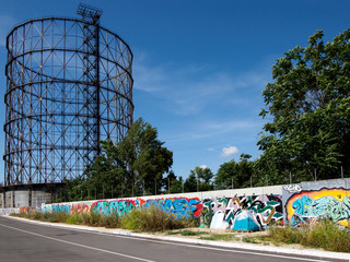 Walking along the Tiber with Gazometro view 7