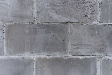 The wall of the old town walls of concrete, gray, porous blocks (fragment)
