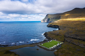 Aerial view of an old football field on the coast near Eidi in Faroe Islands
