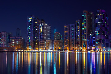 Fototapeta na wymiar United Arab Emirates, Sharjah skyline at night, reflection at Khalid Lake