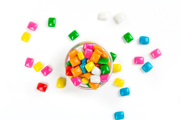Bowl of rounded square unchewed multicolored bubble gum pieces