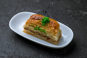 Traditional arabic dessert Baklava on plate. Turkish cuisine