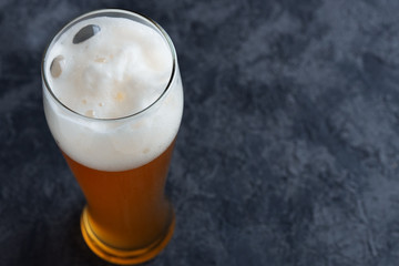 Top view of beer glass with foam cap and copyspace